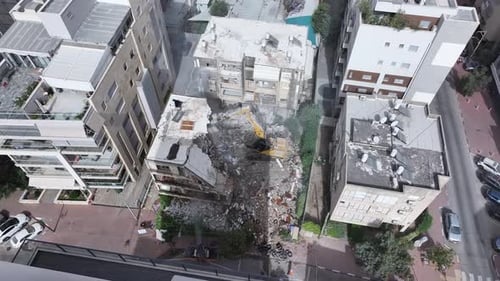 Aerial video of the demolition of an old building and urban renewal in Israel.