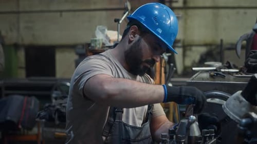 Mechanic Fixing Machinery Equipment at Metalworks Factory
