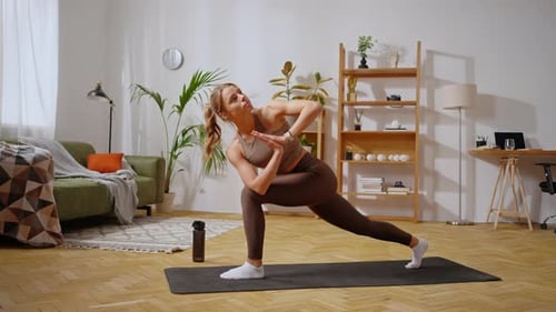 Woman Doing Yoga Exercises in a Bright Living Room