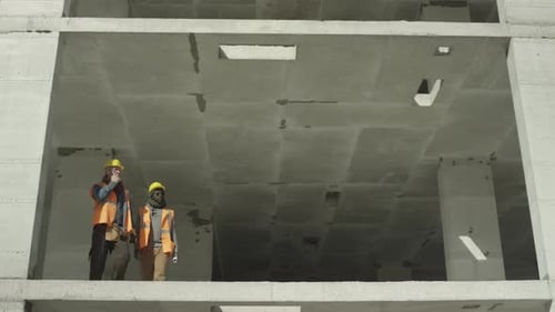 Construction Workers Discussing a Building Project