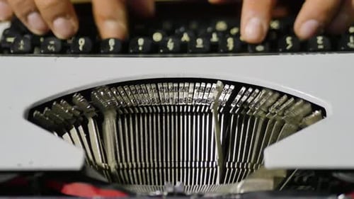 Close Up Over The Top View Of Models Fingers Using Typewriter Focus On Type bars In Motion