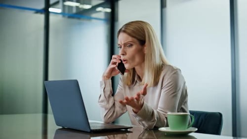 Emotional Businesswoman Calling Cellphone at Office Closeup. Angry Woman Arguing Smartphone Call