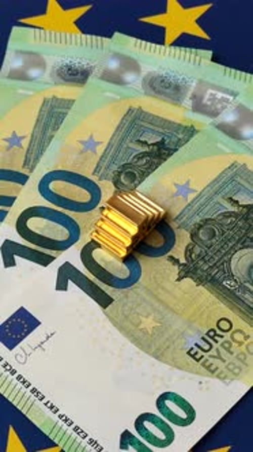 Euro Currency Stack and Gold Bullion on Flag