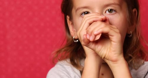 Smiling Girl Makes Shapes With Hands in Close Up