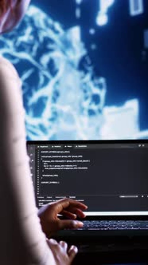 Person Using Laptop With Code in Dark Room