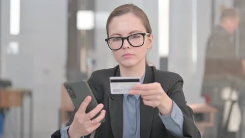 Confused Woman Shopping Online With Credit Card