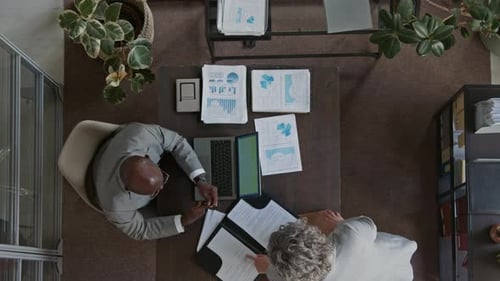 Top View of Female Secretary Giving Male Executive Contract to Sign