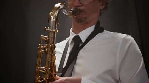 Inspired Male Musician Playing Saxophone on Stage