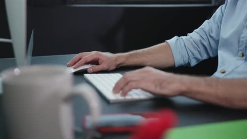 Man Working at Computer in Office Environment