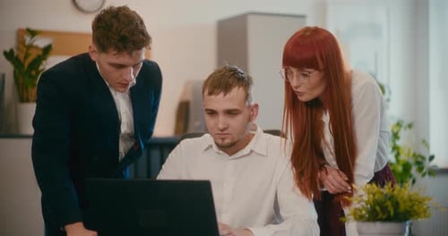 Employees Planning Over Laptop in Office
