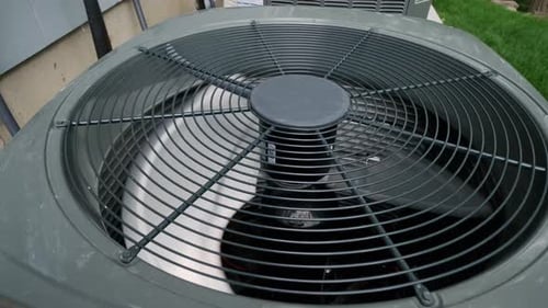 Air Conditioning Unit Fan Spinning on Sunny Day