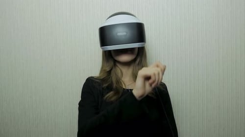 Woman Using Virtual Reality Headset Indoors