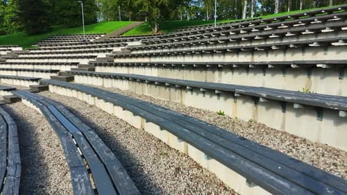 Outdoor Wooden Bleachers Of Open-Air Stadium In Talsi, Latvia. Aerial Pullback Shot