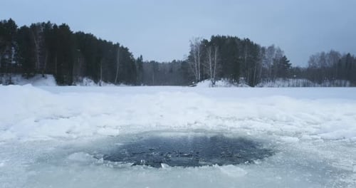 Winter lake with an ice hole