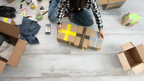 Girl Packing Cardboard Boxes