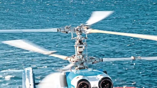 Helicopter Hovering over the Sparkling Ocean