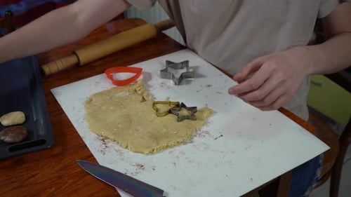 Cutting Christmas Cookie Dough into Star Shapes at Home