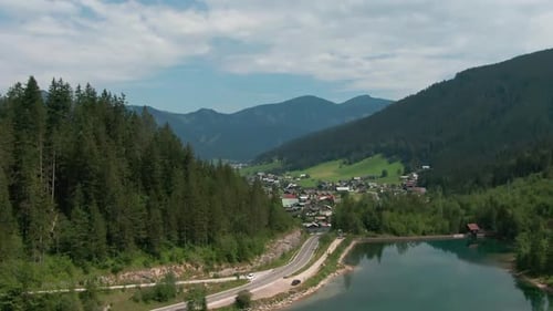 aerial view of Gosau in Austria behind trees and lake and mountains in the back