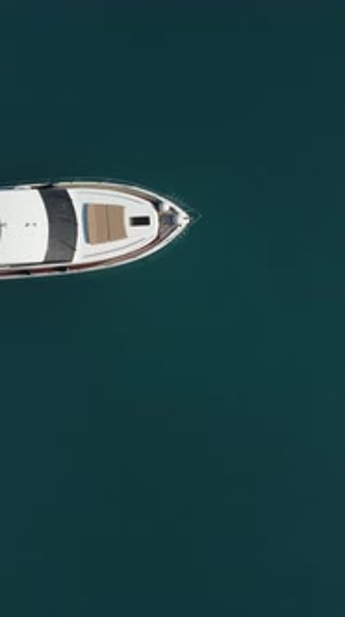 Aerial Yacht on Calm Sea Luxury Cruise Trip View From Above of White Boat on Deep Blue Water Aerial