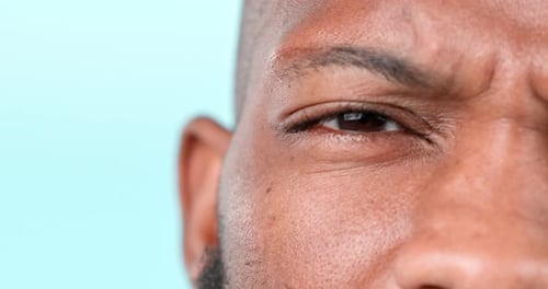 Confused, face and a black man on a studio background for question, doubt or thinking