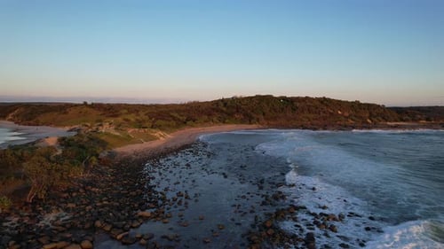 Waves Crashing On The Rocks And Pebbles In Angourie Point Beach During Sunset In Yamba, NSW, Austral