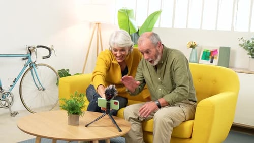 Senior Couple Recording Video with Smartphone at Home