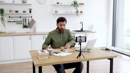 Man Reviews New Smartphone During Online Broadcast