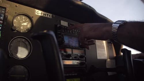 Pilot Inside Cockpit Using Navigation Equipment in Small Airplane