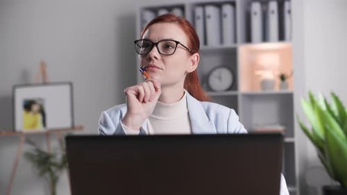 Portrait of Charming Woman Working at Computer While Sitting at Desk in Home Office Smiling and