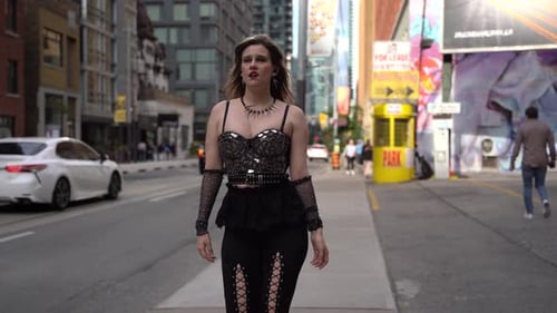 Young woman walking singing on the street in the city center 4K