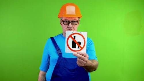 Worker in Overalls Showing Sign No Alcohol and Shakes Fist Who Break Rules