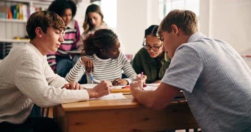 Teen Students Collaborate at a School Desk