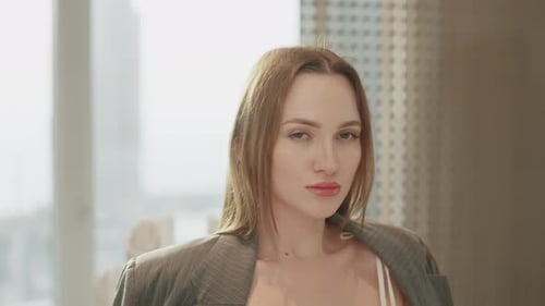 Attractive Woman Posing in a Modern Apartment with a City View