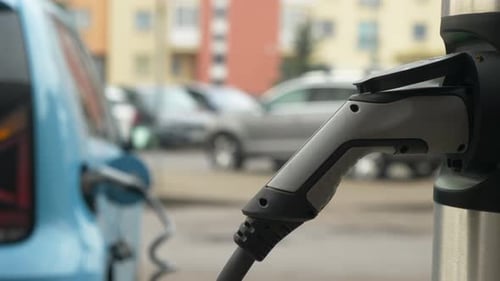Close Up Urban Scene Captures an Electric Car Charging Merging Sustainability with Tech Flair