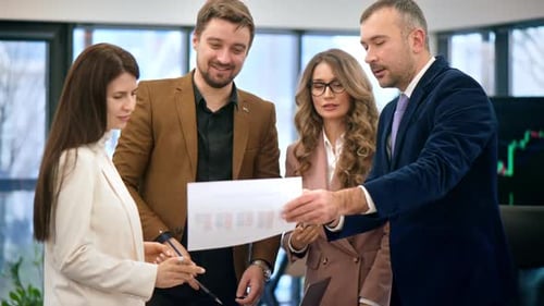 Business meeting in an office, workers discussing business affairs using papers with charts