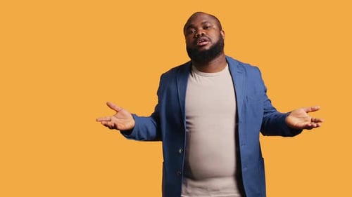 Uncaring Man Shrugs Shoulders Showing Indifference Studio Background