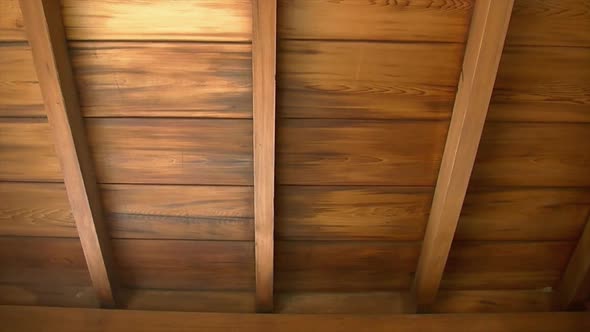 Pan across hinoki wood ceiling and rafters of Japanese house ...