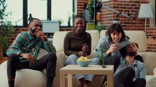 Friends Laughing and Watching TV at Home