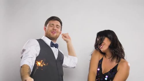 Couple Dancing with Sparklers Celebrating Event Together
