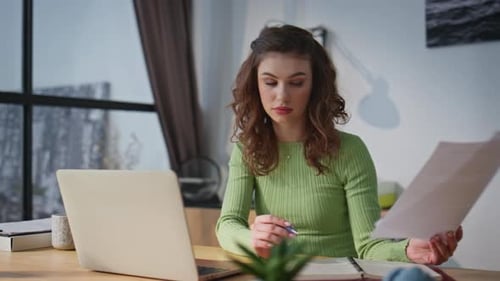 Serious Employee Watching Papers in Office Closeup Secretary Typing Laptop