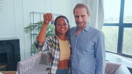 Smiling Couple Holding Keys to New Home