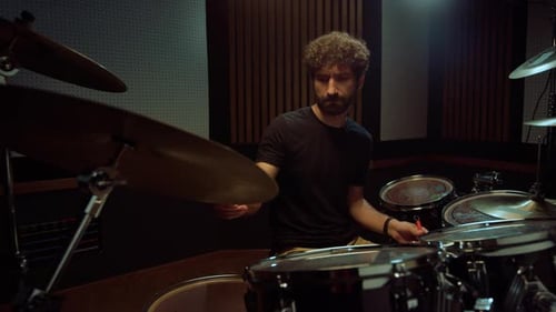 Emotional Drummer Playing on Drum Kit in Recording Studio. Focused Male Artist