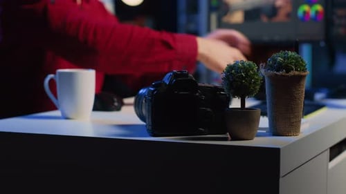 Bearded Man Reviews Camera Images at Desk