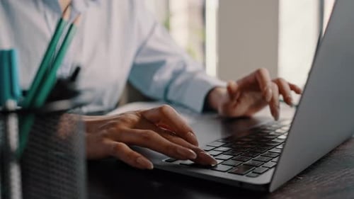 Cropped View Hands Working on Laptop Typing Text on Keyboard