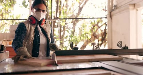 Woman Using Table Saw in Bright Workshop