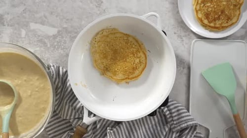 Flat Lay Frying Coconut Banana Pancakes on a Nonstick White Frying Pan