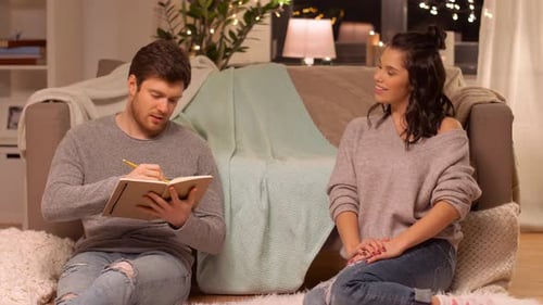 Young Couple Relaxing Indoors at Night