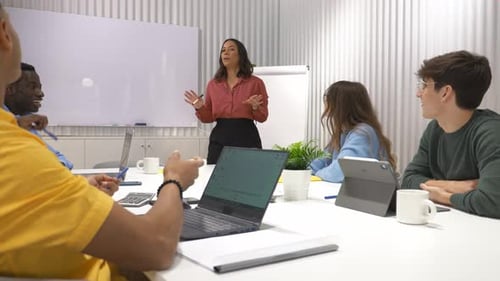 Businesswoman Leading Creative Meeting with Diverse Team in Modern Office