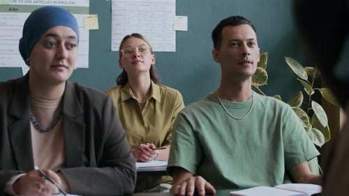Engaged Students Listening to Speaker in Classroom