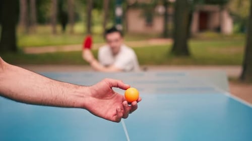Close-up of serving a ping pong ball against the background of an opponent in the game